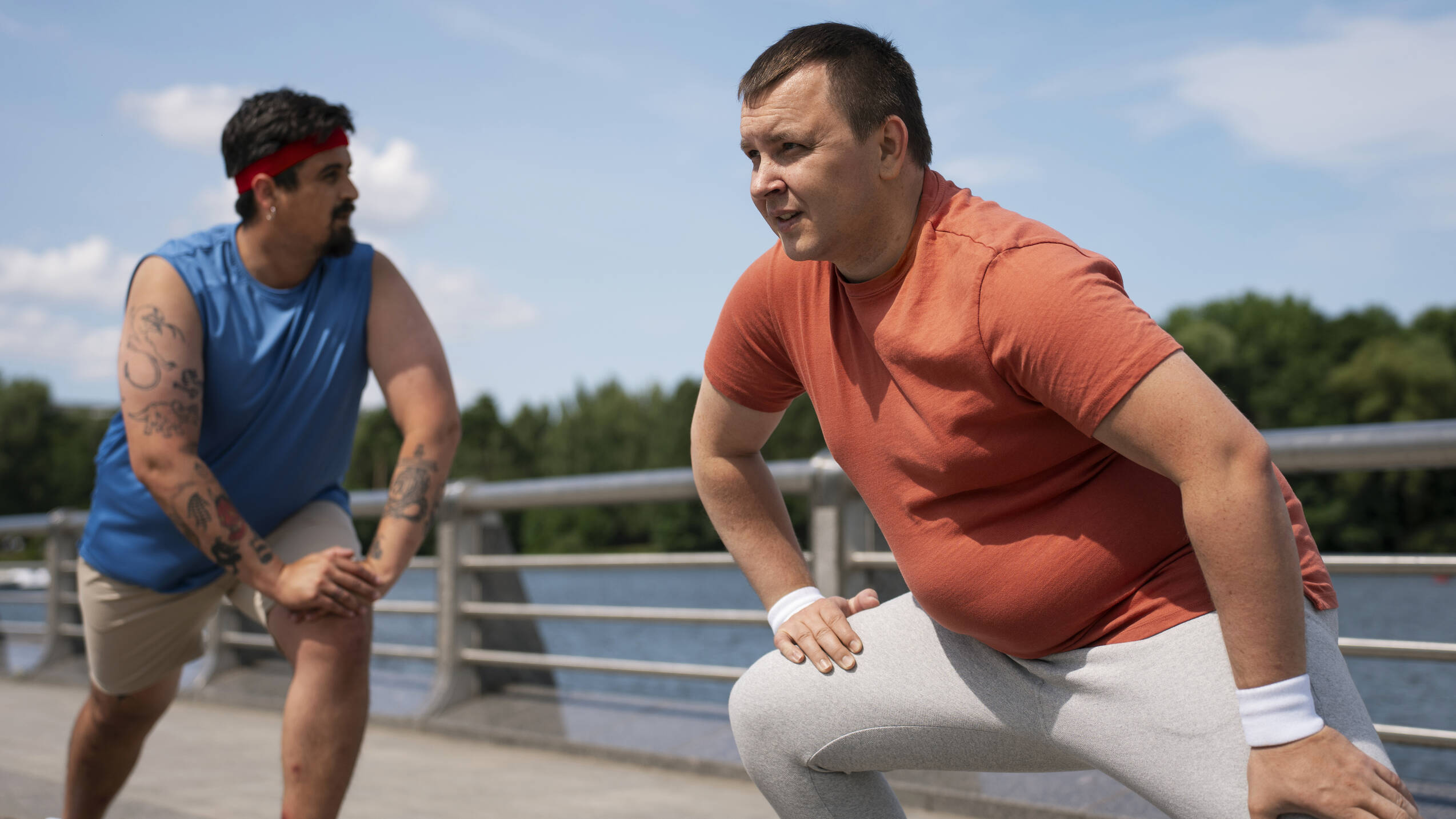 Side view men exercising together outdoors
